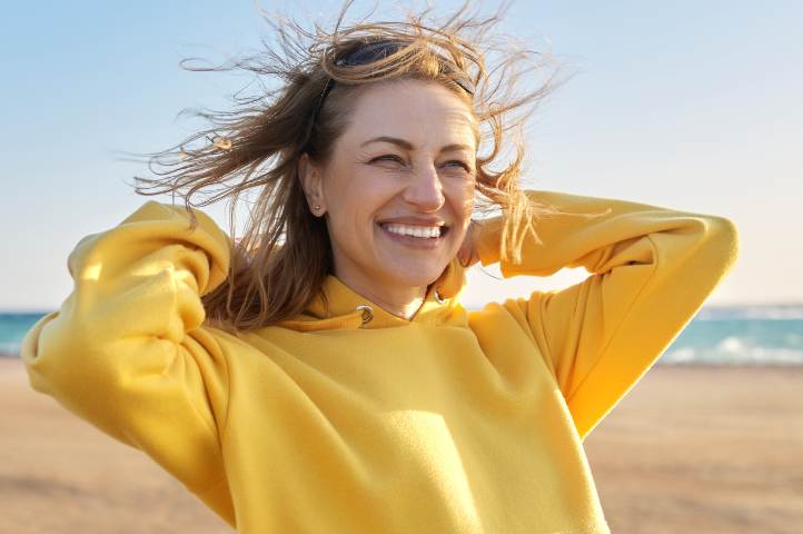 Loes, 39 jaar Blije vrouw wandelt op strand zonder voorzorgsplas door Rust in je blaas training.